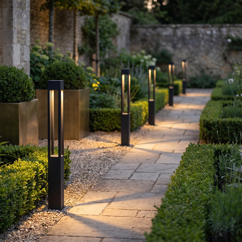 Line of Verdano bollard lights along a stone garden path at dusk