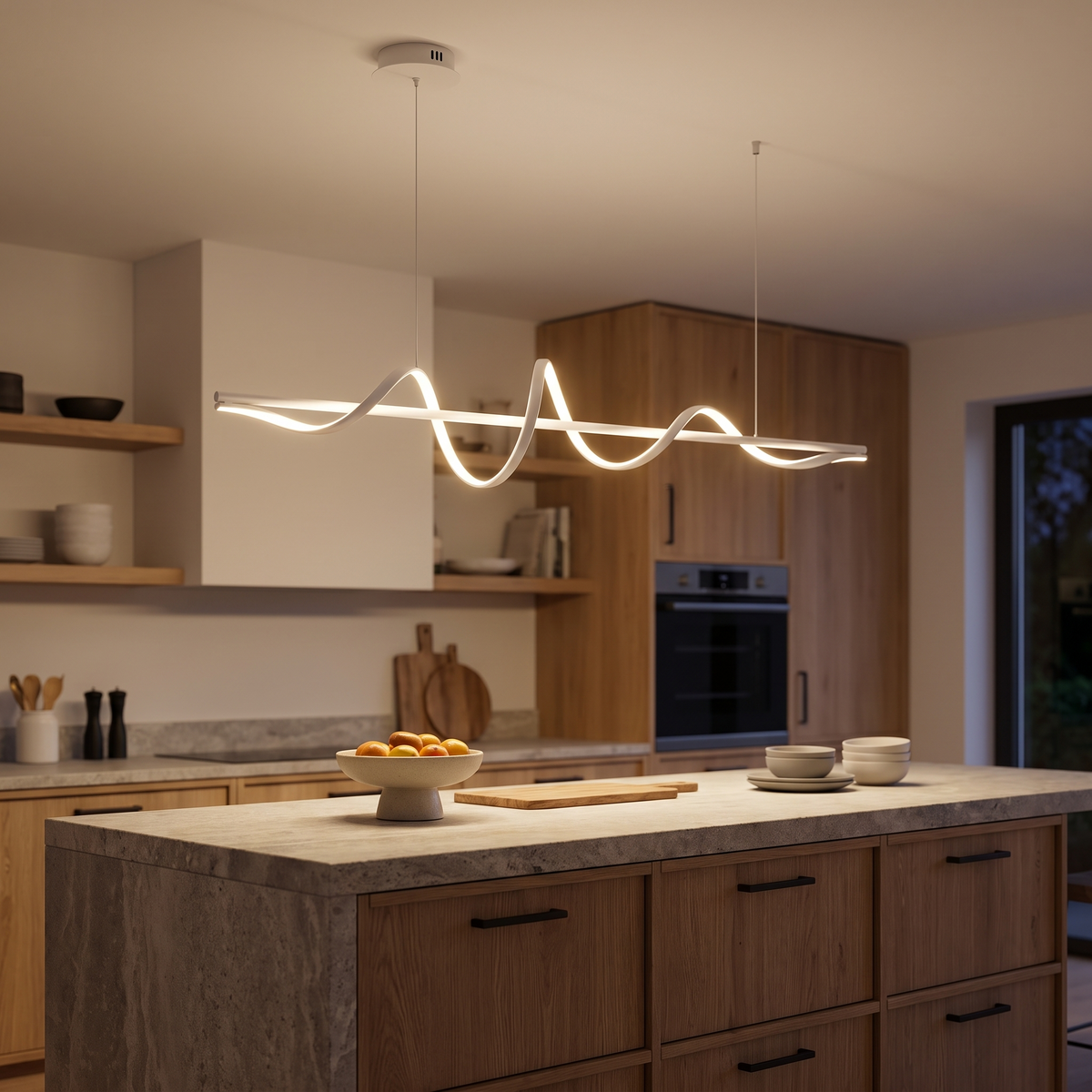 Ondelle chandelier above a stone kitchen island at night